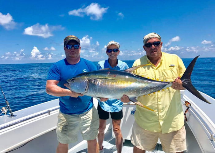 Apalachicola Fishing Company group of 3 holding a huge fish